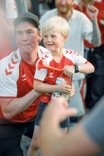 Danish football fans, dad is lifting his son up. Shot with Cinestill 800 with the Tamron SP 85mm F/1.8 Di VC USD. Not sure if you see but the colors are just a little bit off, same problem I had with all my Cinestill scans.