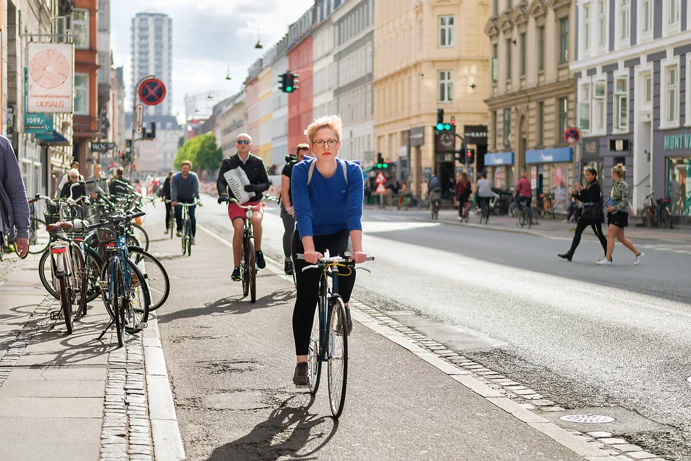 Woman cycling in the bike lane on Vesterbrogade