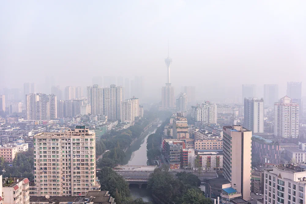 Chengdu skyline and river disappearing into thick fog