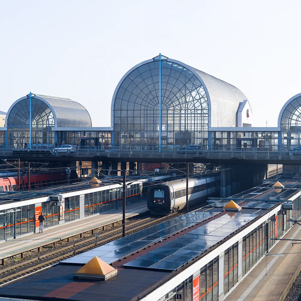 Trains at Høje Taastrup Station under its large glass dome roofs
