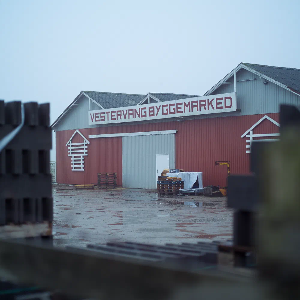 Red Vestervang Byggemarked warehouse building on a wet day