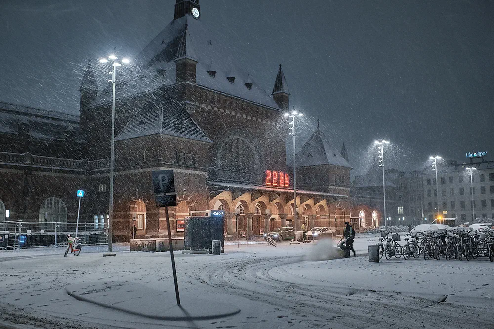 Copenhagen Central Station at night in falling snow